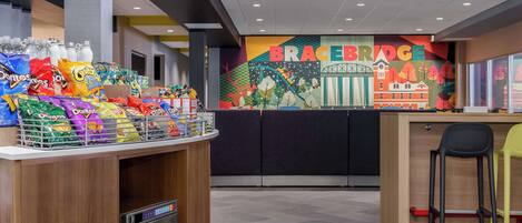 A snack bar with various packaged snacks and a coffee machine.