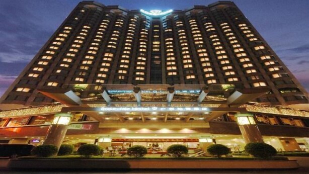 A high-rise hotel with a central atrium, multiple floors, and a prominent entrance with a canopy. - Rosedale Hotel & Suites (Guangzhou)