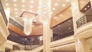 A multi-level interior with ornate columns, a grand chandelier, and a spacious atrium with balconies. - Rosedale Hotel & Suites (Guangzhou)