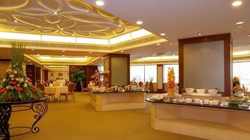 A hotel lobby with a reception desk, seating area, and a Christmas tree.