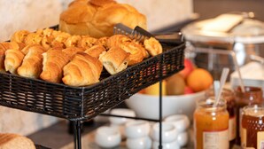 A buffet with a variety of pastries and condiments.