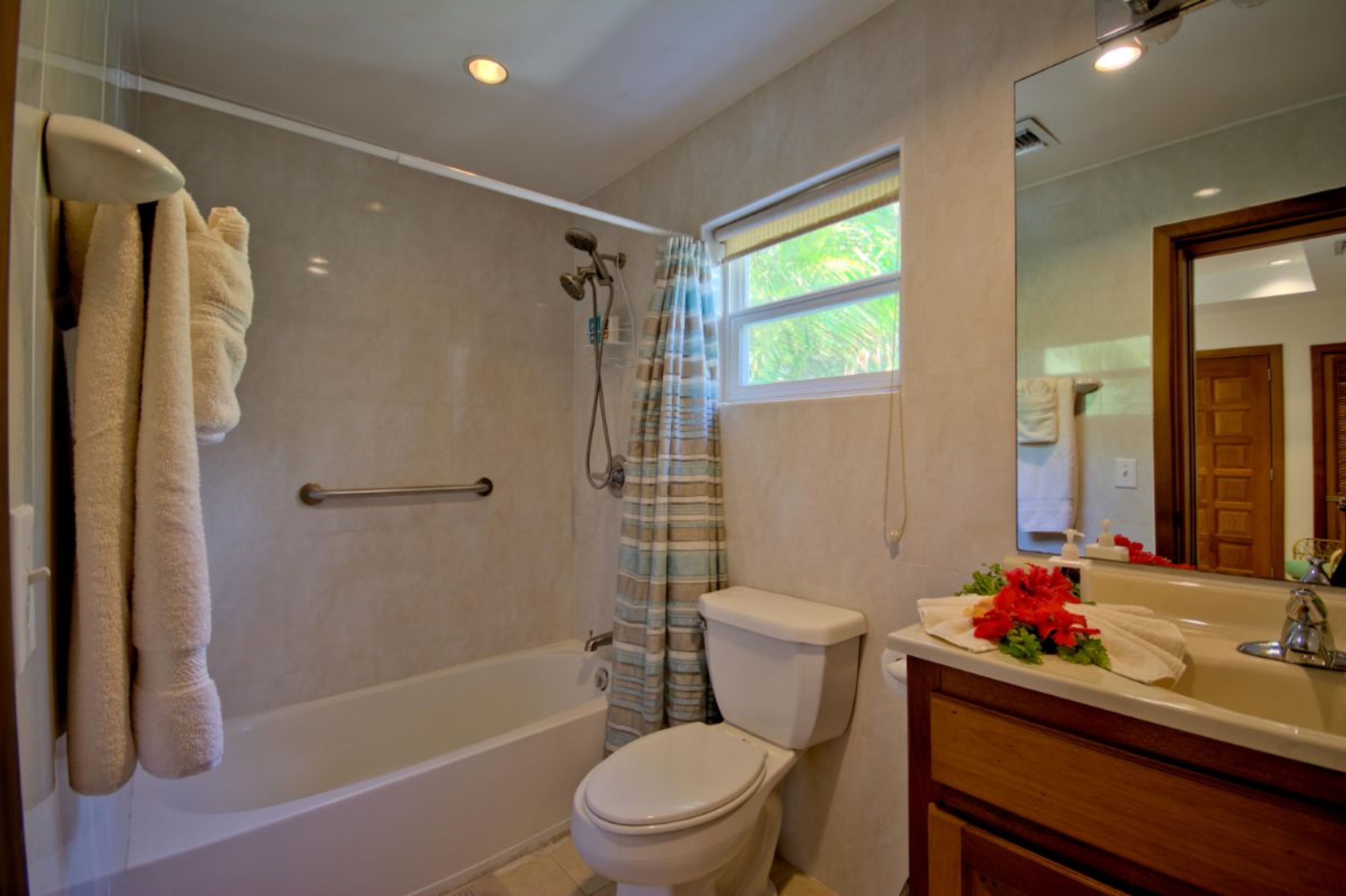 Une salle de bain équipée d’une baignoire, de toilettes et d’un meuble-lavabo avec un miroir.