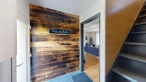A modern interior with a wooden wall and a staircase. - Apartment Grand Standing 🍀 (Épinay-sur-Seine)