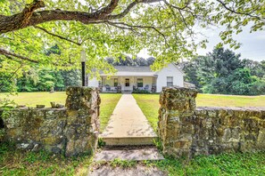 A pathway leading to a house with a porch, surrounded by stone walls and greenery. - ‘Historic Hawkins House’ Located on Sewanee Campus (Sewanee)