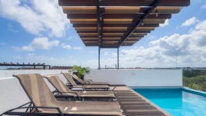 A rooftop pool area with lounge chairs and a pergola. - Quinto Sol Tulum (Tulum)