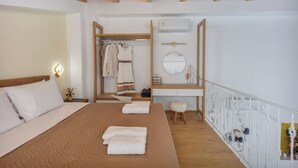 A bedroom with a bed, bedside table, and a wardrobe.