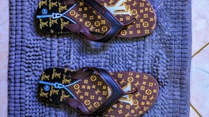 A pair of flip-flops on a textured mat. - Golden Court (Kampala)