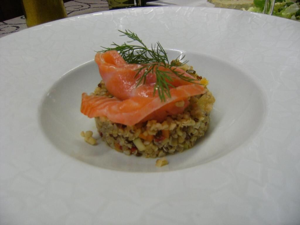 A dish with salmon and dill on a white plate.