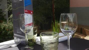 A table set with wine glasses and a menu stand.