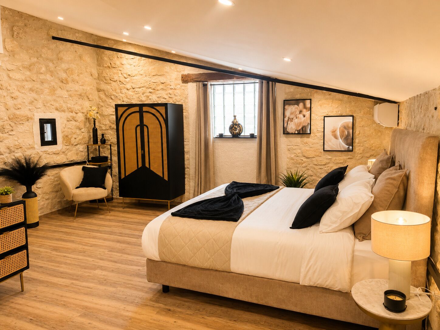 A bedroom with a bed, a chair, a lamp, and a large decorative cabinet.
