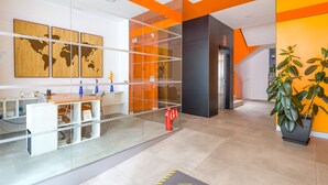 A modern reception area with a desk, computer, and a world map on the wall. - VIVENTE 3C BY CANARIAS GETAWAY (Las Palmas de Gran Canaria)