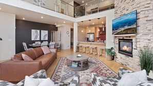 A spacious living area with a high ceiling, a fireplace, and a dining area. - 3min Walk to Ski Lifts*Hot Tub*Sauna*Views (Brian Head)