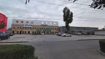 A multi-story building with signage for a hotel and a business center.