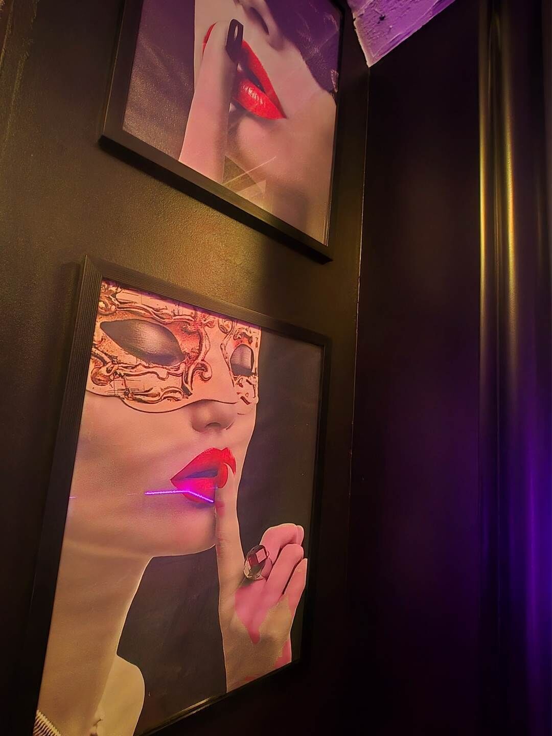 Two framed artworks on a wall.