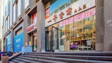 Un bâtiment dont la façade comprend une vitrine avec de grandes fenêtres en verre et une enseigne avec des caractères chinois.
