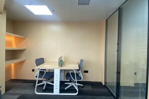 A conference room with a table, chairs, and a glass partition. - Century Hongyuan Hotel (Chongqing Road Branch) (Changchun)