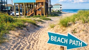 A beach path sign, a wooden staircase leading to a blue building, and the beach. - Fishy Business| Beach Front Oasis!  Sleeps 20! (Bolivar Peninsula)
