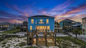 A beachfront hotel with a two-story structure, a covered deck area, and a pool. - Fishy Business| Beach Front Oasis!  Sleeps 20! (Bolivar Peninsula)