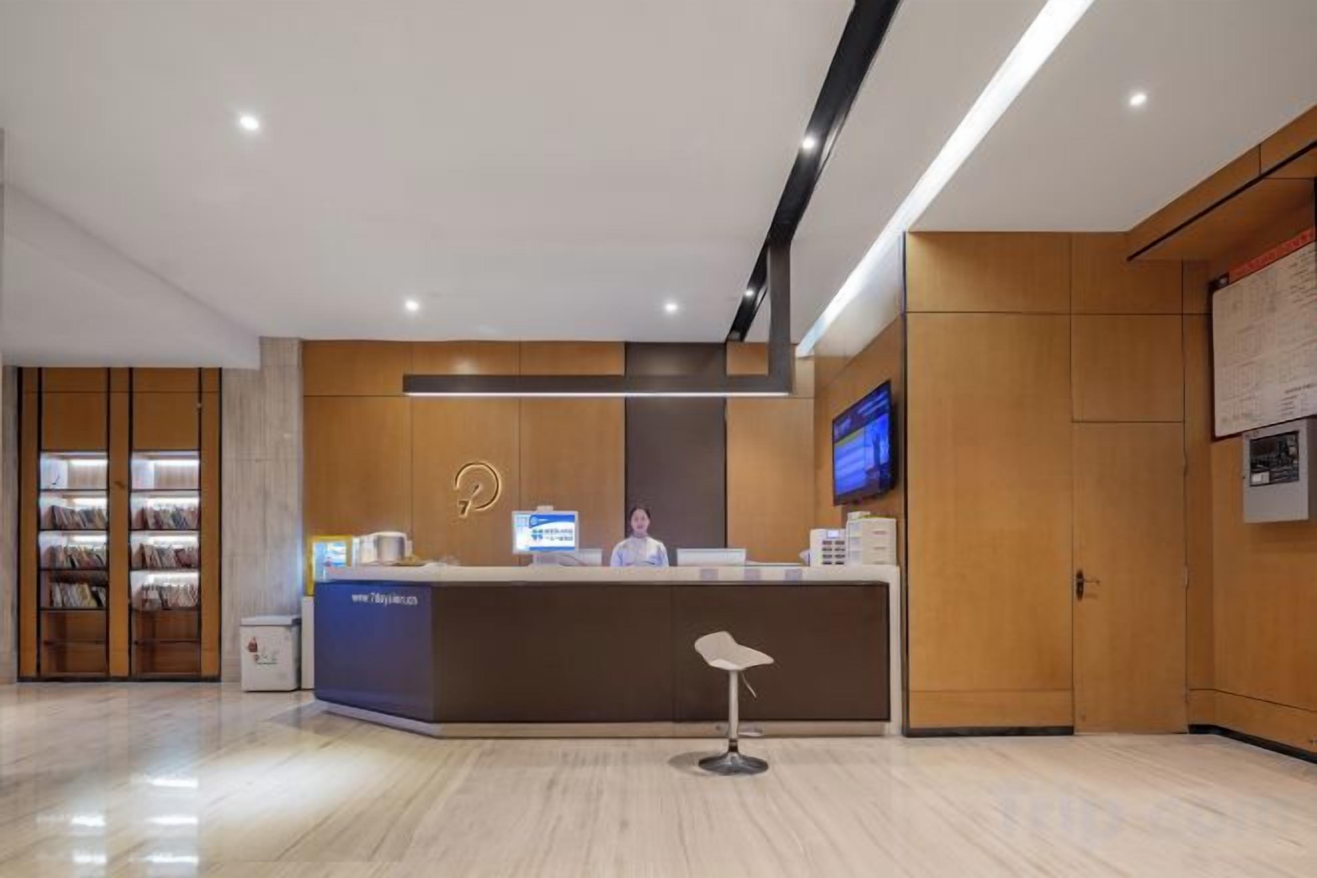 A reception area with a desk, a television, and a bulletin board.