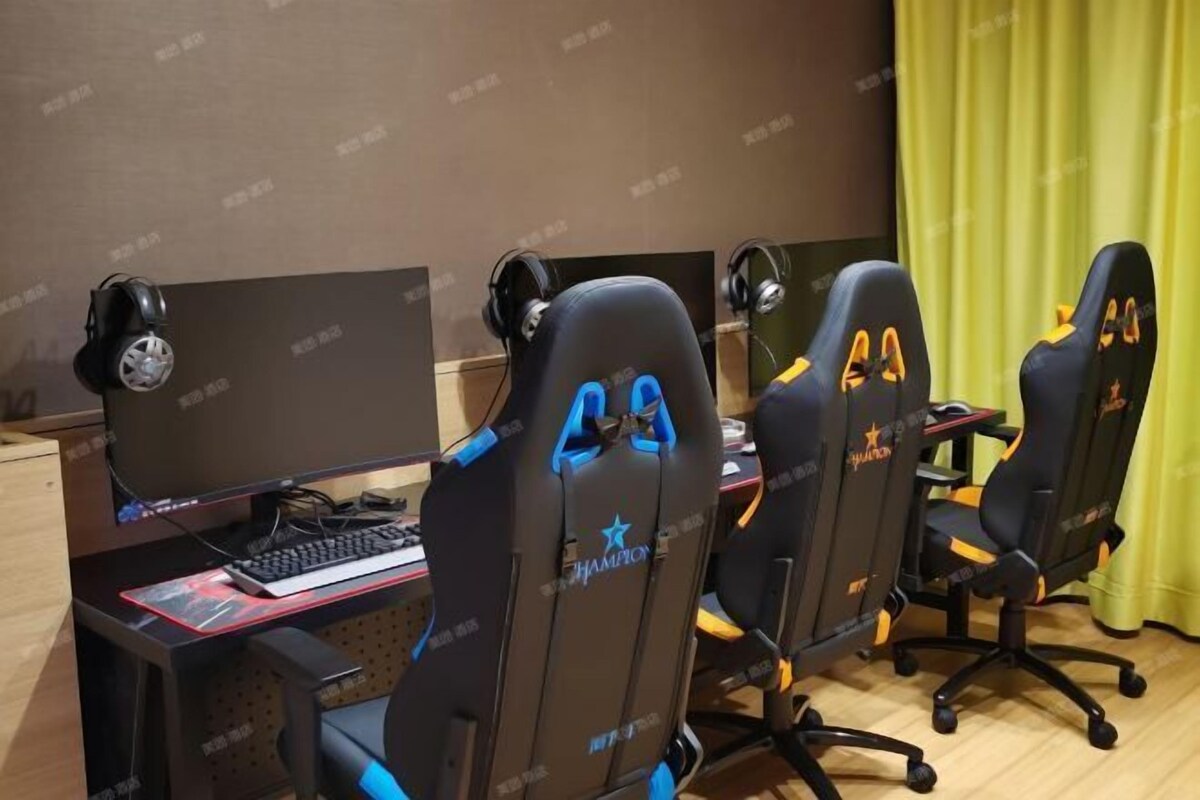 A gaming setup with four black gaming chairs, each with a number and a star logo.