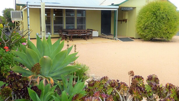A building with a covered patio area, a bench, and a small table. - Gunnadoo, Moonta Bay (Moonta Bay)