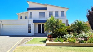 A modern two-story house with a garage, a well-maintained lawn, and various plants in the front yard. - Happy Days, Wallaroo (Wallaroo)