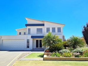 A modern two-story house with a garage, a well-maintained lawn, and various plants in the front yard. - Happy Days, Wallaroo (Wallaroo)
