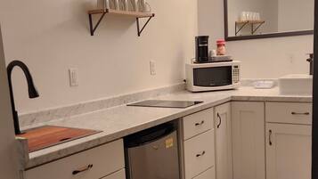 Fridge, microwave, coffee/tea maker, cookware/dishes/utensils