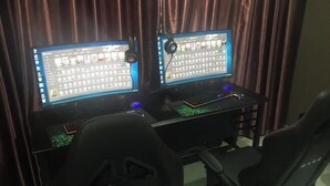 A gaming setup with two monitors, a keyboard, and a mouse.