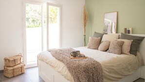 A bedroom with a bed, a window, and a door. - Maison Loutina, Villa 5-10 min à Pied du Centre (L'Isle-sur-la-Sorgue)