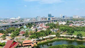 Un paisaje urbano con río, áreas verdes y un puente.