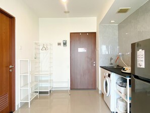 Deluxe Studio | Private kitchen | Full-sized fridge, stovetop - Simply Look Studio At Grand Kamala Lagoon Apartment (Bekasi)