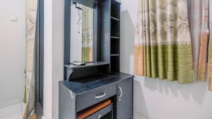 A room with a black cabinet featuring a mirror, shelves, and a small countertop. - Homey And Tidy Studio Dramaga Apartment Near Ipb (Dramaga)
