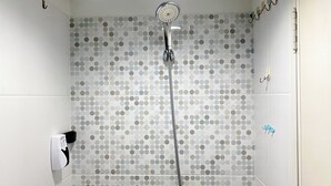 A shower with a circular showerhead and a hose. - Minimalist Studio Grand Sentraland Karawang Apartment (Karawang)