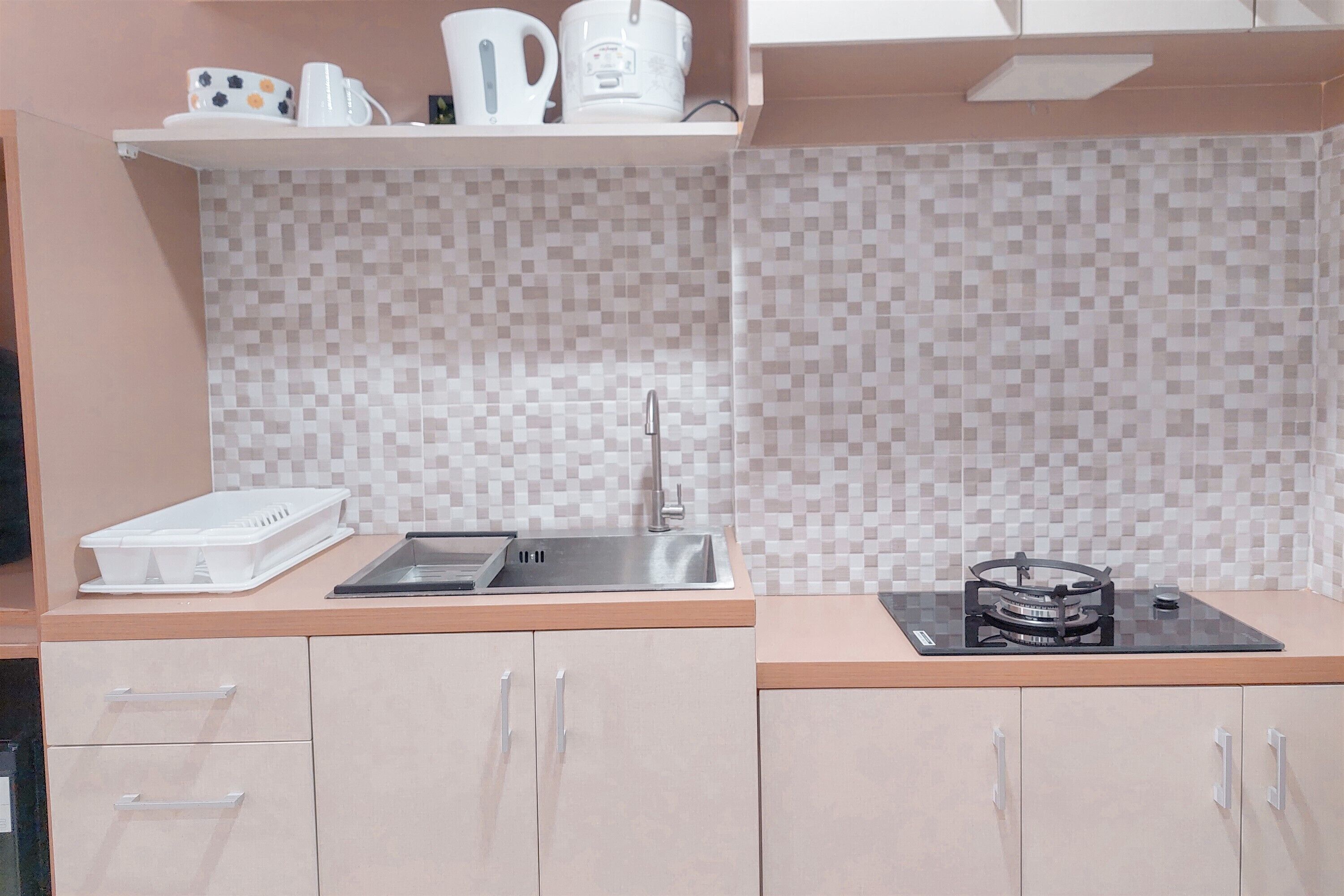 A modern kitchen with a microwave, sink, and gas stove. There are cabinets and a countertop.