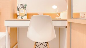 A white chair with a wooden base, a white desk, and a small white lamp. - Good And Cozy Stay 2Br Tokyo Riverside Pik 2 Apartment (Teluknaga)