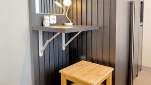 A wooden stool under a wall-mounted shelf with a mirror and a desk lamp. - Spacious 1Br At Tokyo Riverside Pik 2 Apartment (Teluknaga)