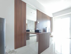 Deluxe Apartment | Private kitchen | Full-sized fridge, stovetop, dining tables - Compact And Relaxing 1Br At Grand Sungkono Lagoon Apartment (Surabaya)