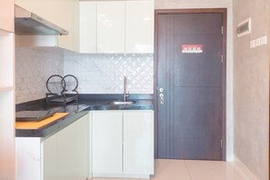 Deluxe Apartment | Private kitchen | Full-size fridge, stovetop, dining tables - Warm And Homey 1Br At Brooklyn Alam Sutera Apartment (South Tangerang)
