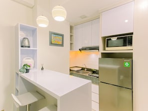 Deluxe Apartment | Private kitchen | Full-sized fridge, microwave, stovetop, dining tables - Good Place And Homey 2Br At Transpark Cibubur Apartment Near Mall (Depok)