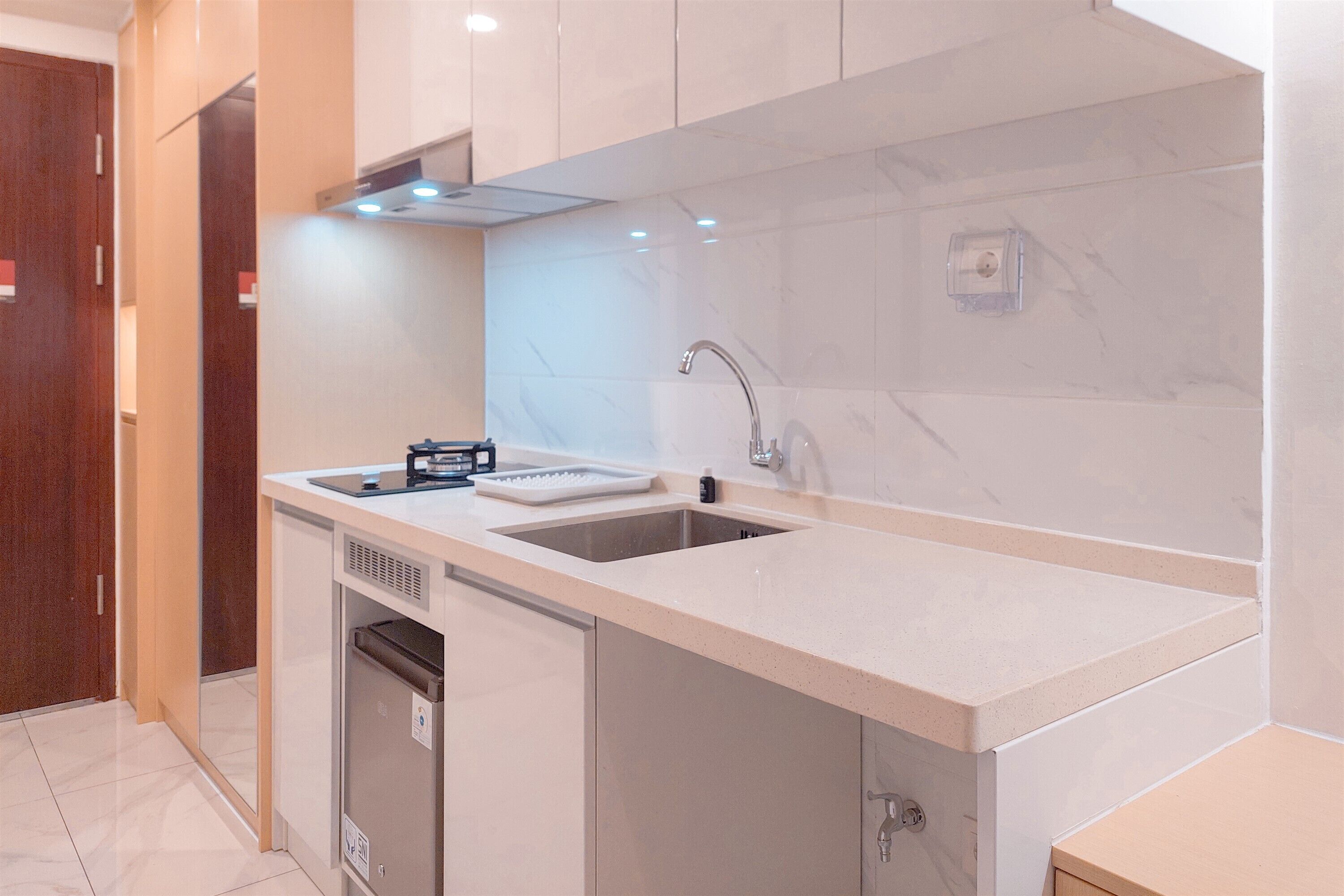 A modern kitchen with a double sink, built-in dishwasher, and stainless steel appliances.