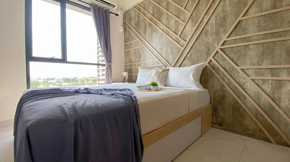 A modern bedroom with a bed, a window with curtains, and a geometric wall design.
