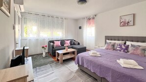 A bedroom with a bed, a sofa, a small table, and a desk. - Gorgeous apartment in Pula with WiFi (Pula)