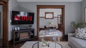 Smart TV, fireplace, books, computer monitors