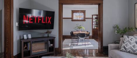 Smart TV, fireplace, books, computer monitors