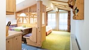A cozy room with a wooden bunk bed, a desk with a chair, and a window with curtains. - Haus Katharina - Dorfblick (Kaprun)