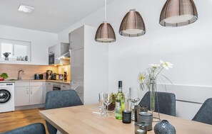Enjoy meals in the well-equipped kitchen with oven and dishwasher, and dine at the wooden table with glassware.