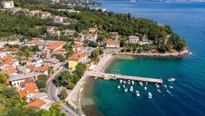 An aerial view of a coastal town with a marina, buildings, and a pier. - 1 bedroom lovely apartment in Ika (Ika)
