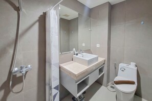 Deluxe Studio | Bathroom | Shower, free toiletries, towels - Homey And Scenic Studio At Patraland Amarta Apartment (Ngaglik)