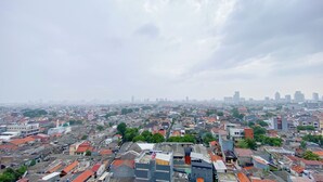Un quartier urbain densément peuplé, où se côtoient des immeubles résidentiels et commerciaux, et où l’on trouve notamment une église remarquable, surmontée d’un dôme.